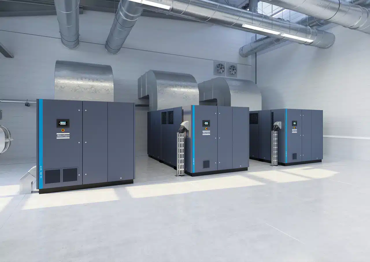 Three Atlas Copco compressors with ducted cooling hoods in a plant room