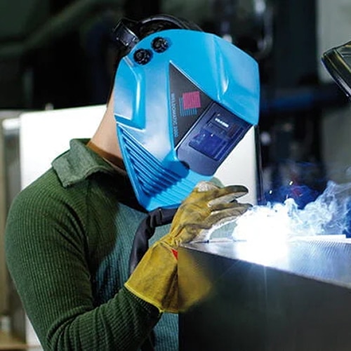 Welder working under fume extraction