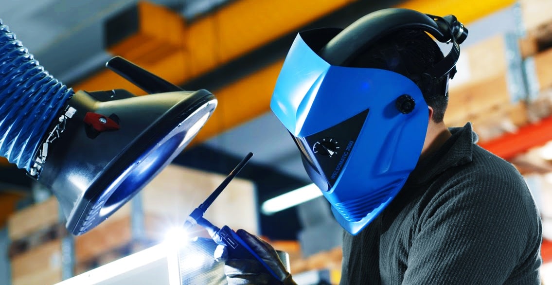 Welder working under a fume extraction arm