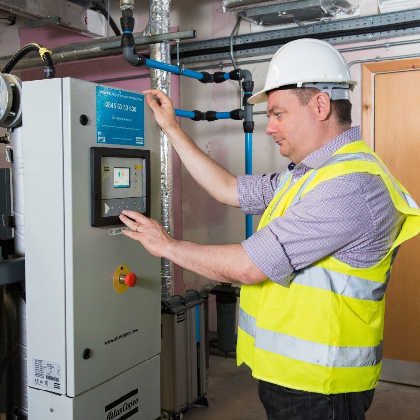 Engineer at a compressor control panel