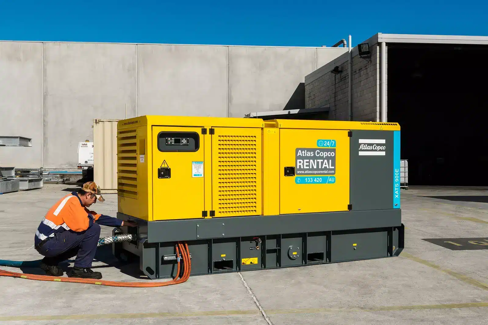 Engineer connecting an Atlas Copco hire compressor